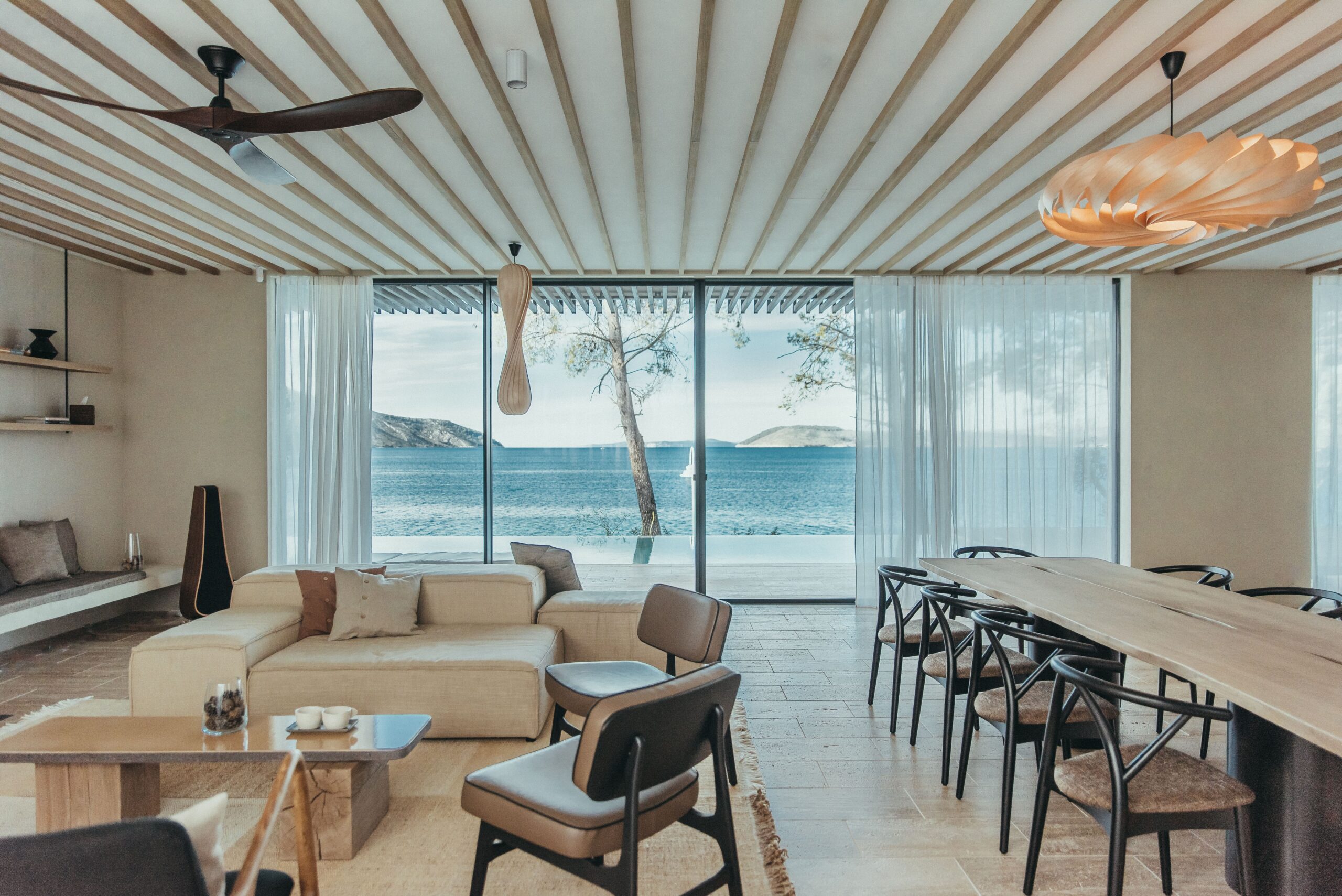 MaslinaResort_VillaUvala_01_KateSevo Interior of a villa at Maslina Resort with contemporary design, natural wood accents, large windows, and views of the sea.