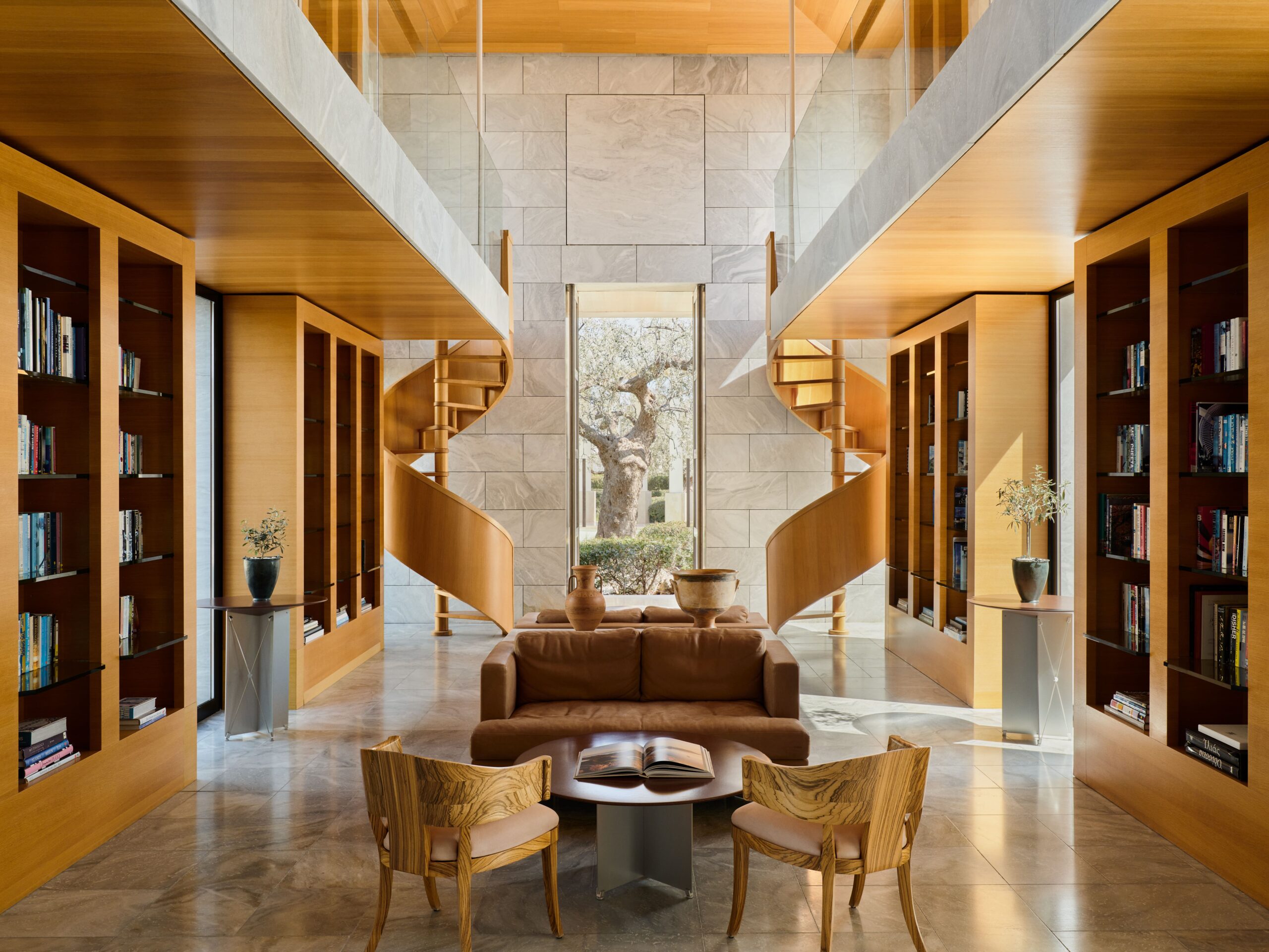 Amanzoe, Greece - Resort, Library Elegant, minimalist-style restaurant with floor-to-ceiling windows and a poolside terrace, offering panoramic views of the Adriatic Sea; features natural materials like terracotta and wood, reflecting the surrounding olive groves and vineyards.